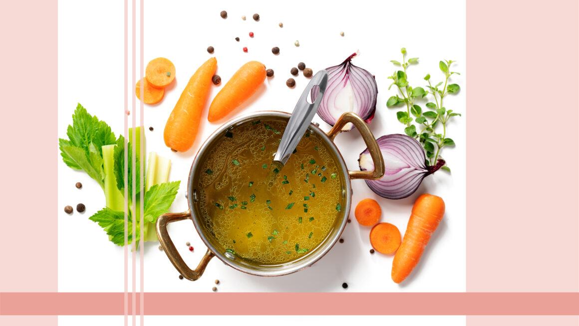 A saucepan with vegetables around with bone broth in the pan.